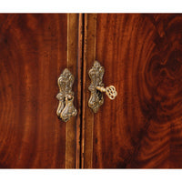 Decorative lock and key on sideboard cabinet doors.