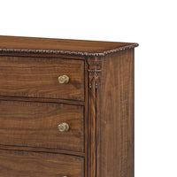 Detailed corner carving on English six drawer dresser.