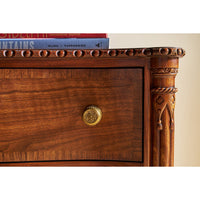 Corner detail of English six drawer dresser with books.