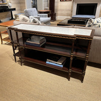 English console table with books, displayed in living room.