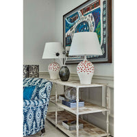 Console table styled with lamps and books in a room.