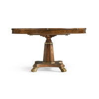 Round dining table with ornate base details.
