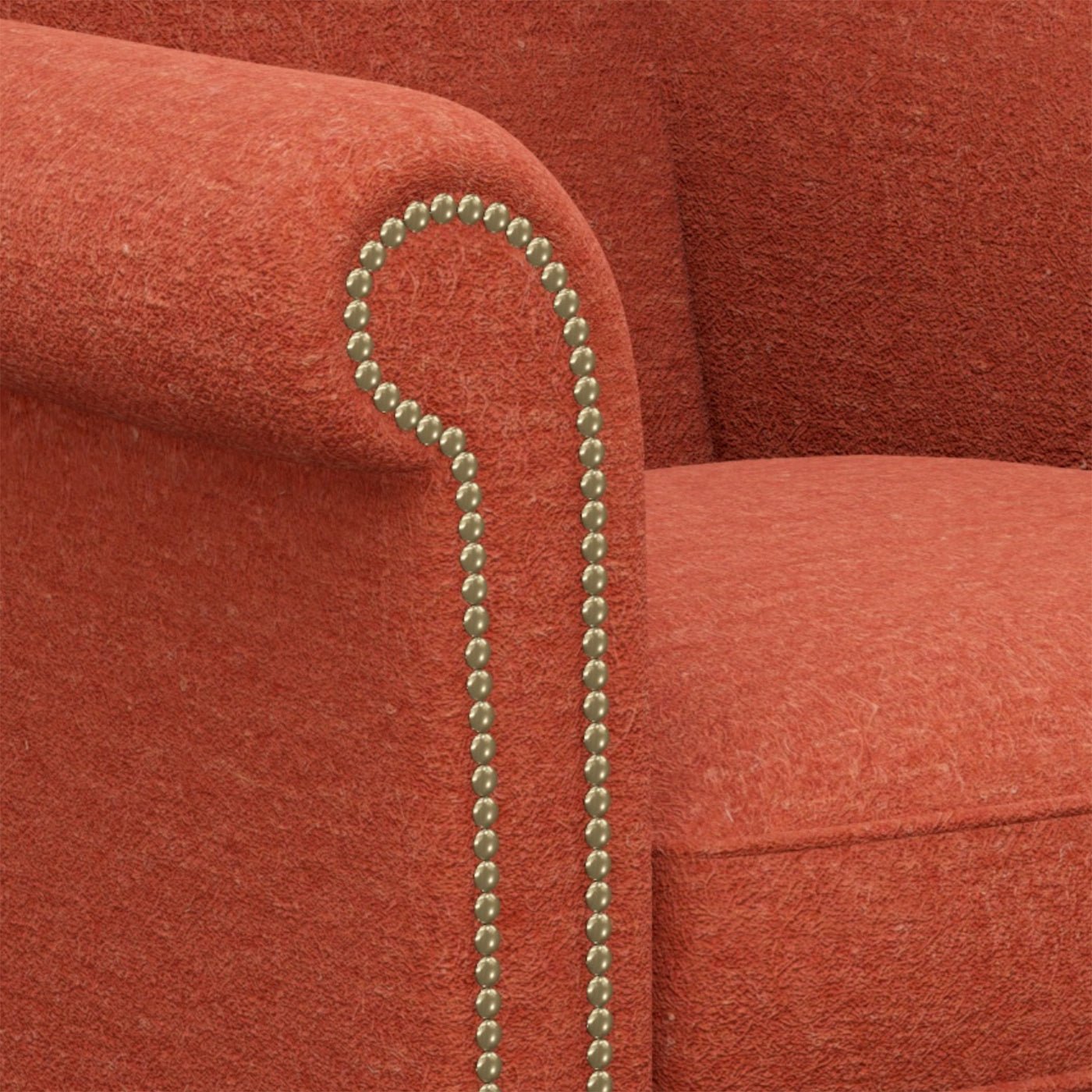 Armrest nailhead detail on red English wingchair.
