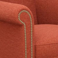 Armrest nailhead detail on red English wingchair.