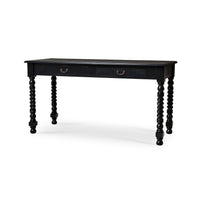Black rustic desk with turned legs, angled view.