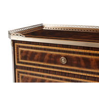 Close-up of nightstand's top with decorative brass border.