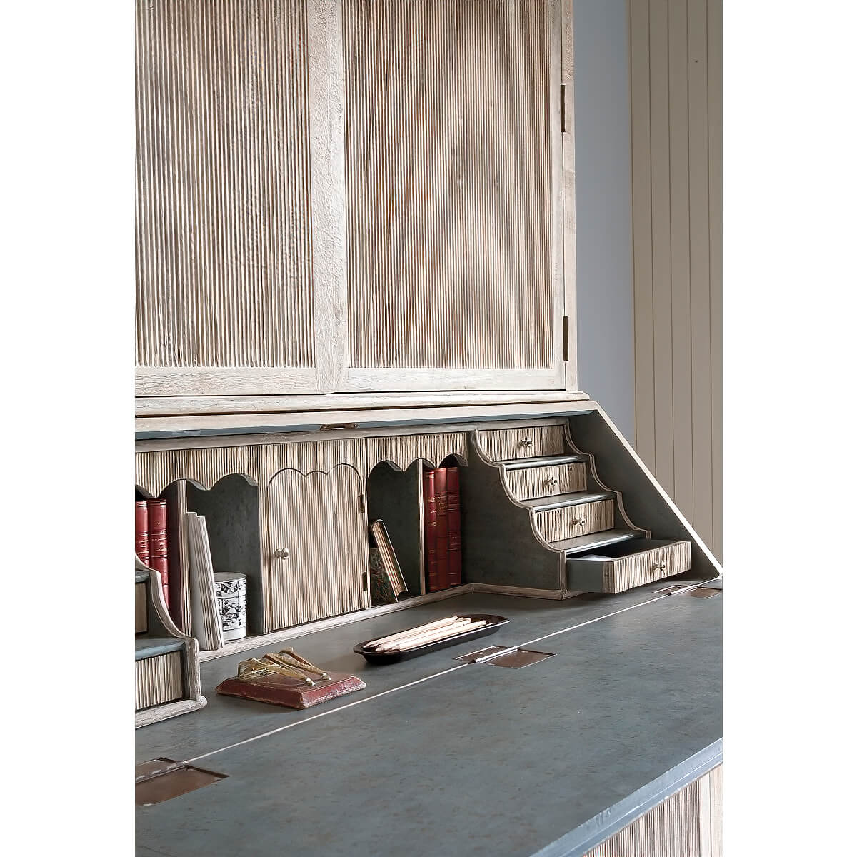 Desk section styled with books and decorative items.