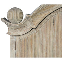 Close-up of ornate finial on bookcase top.