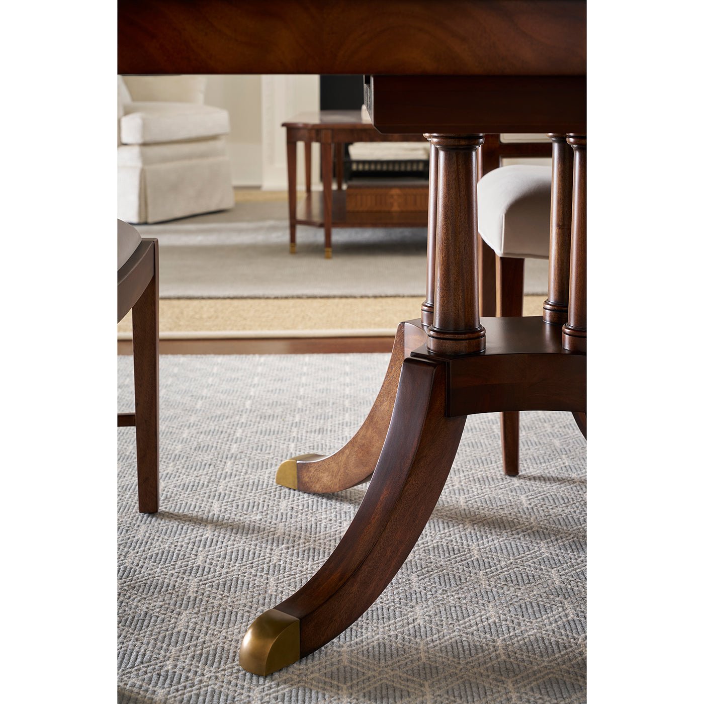 Pedestal detail, extending English dining table with gold accents.