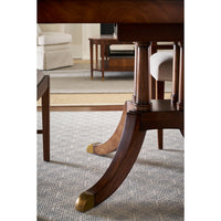 Pedestal detail, extending English dining table with gold accents.