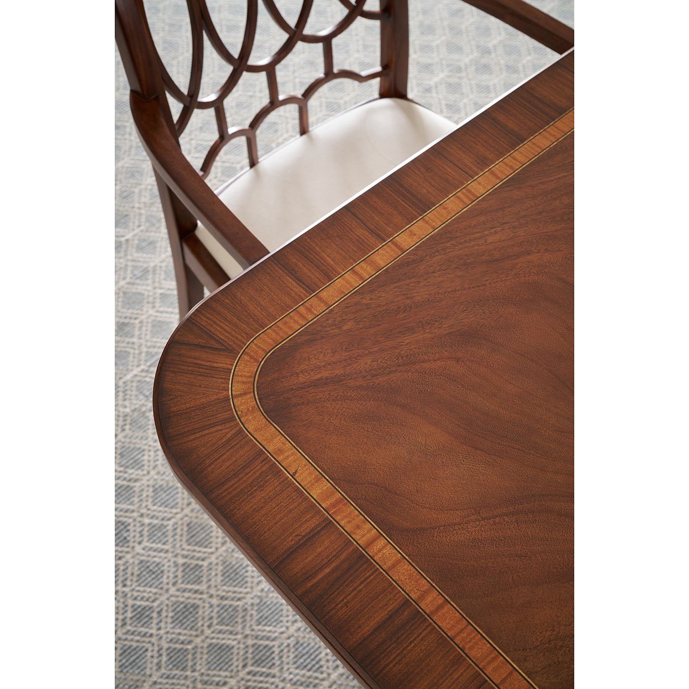 Close-up of table and chair, extending English dining table pattern.
