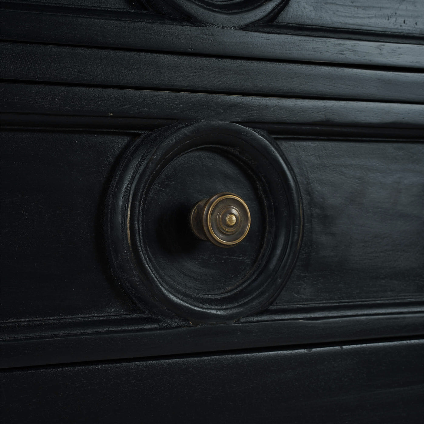 Close-up of sideboard drawer with circular handle.