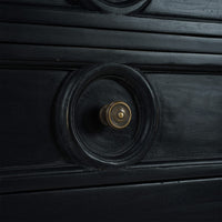 Close-up of sideboard drawer with circular handle.