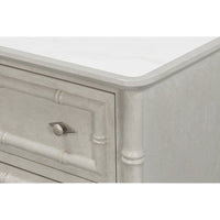Corner detail of faux bamboo chest with knob.