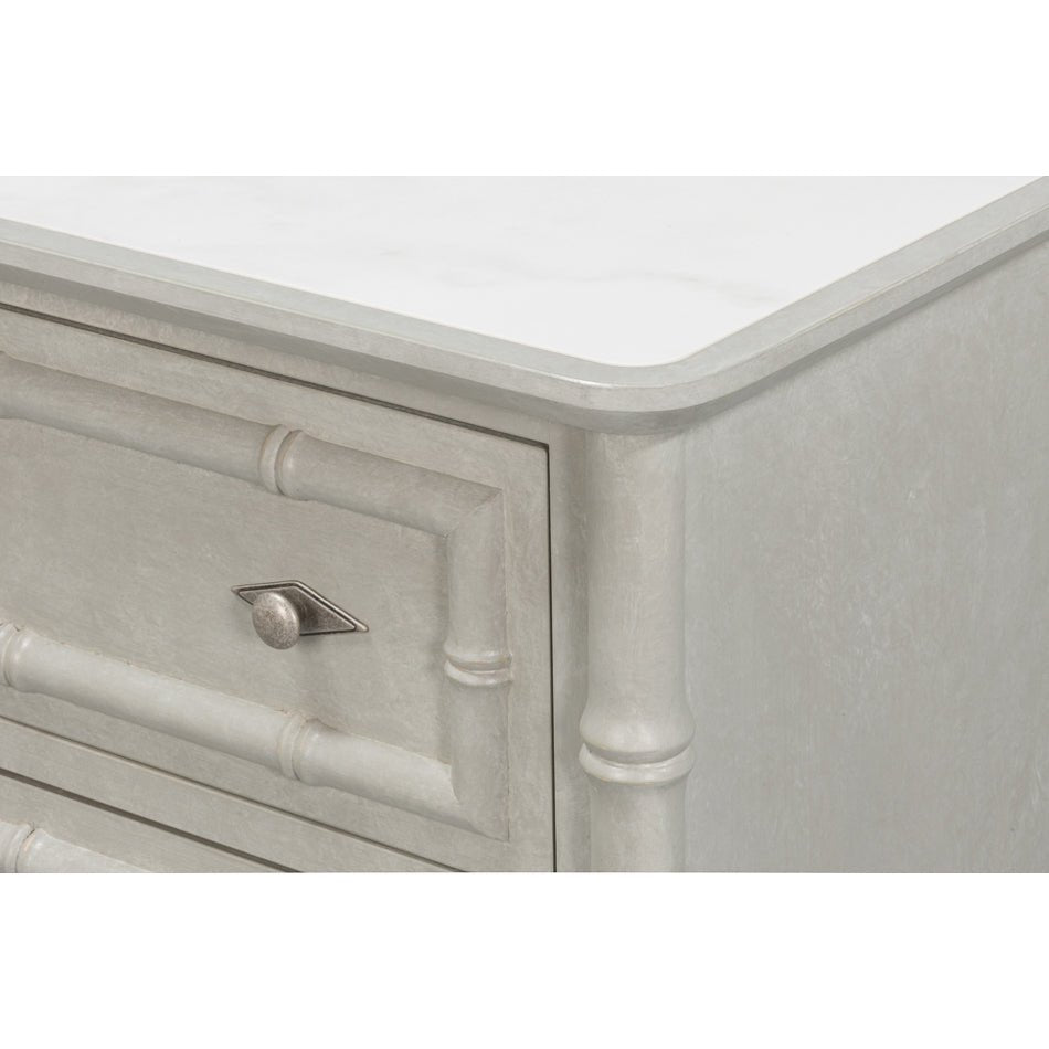 Corner detail of faux bamboo chest with knob.