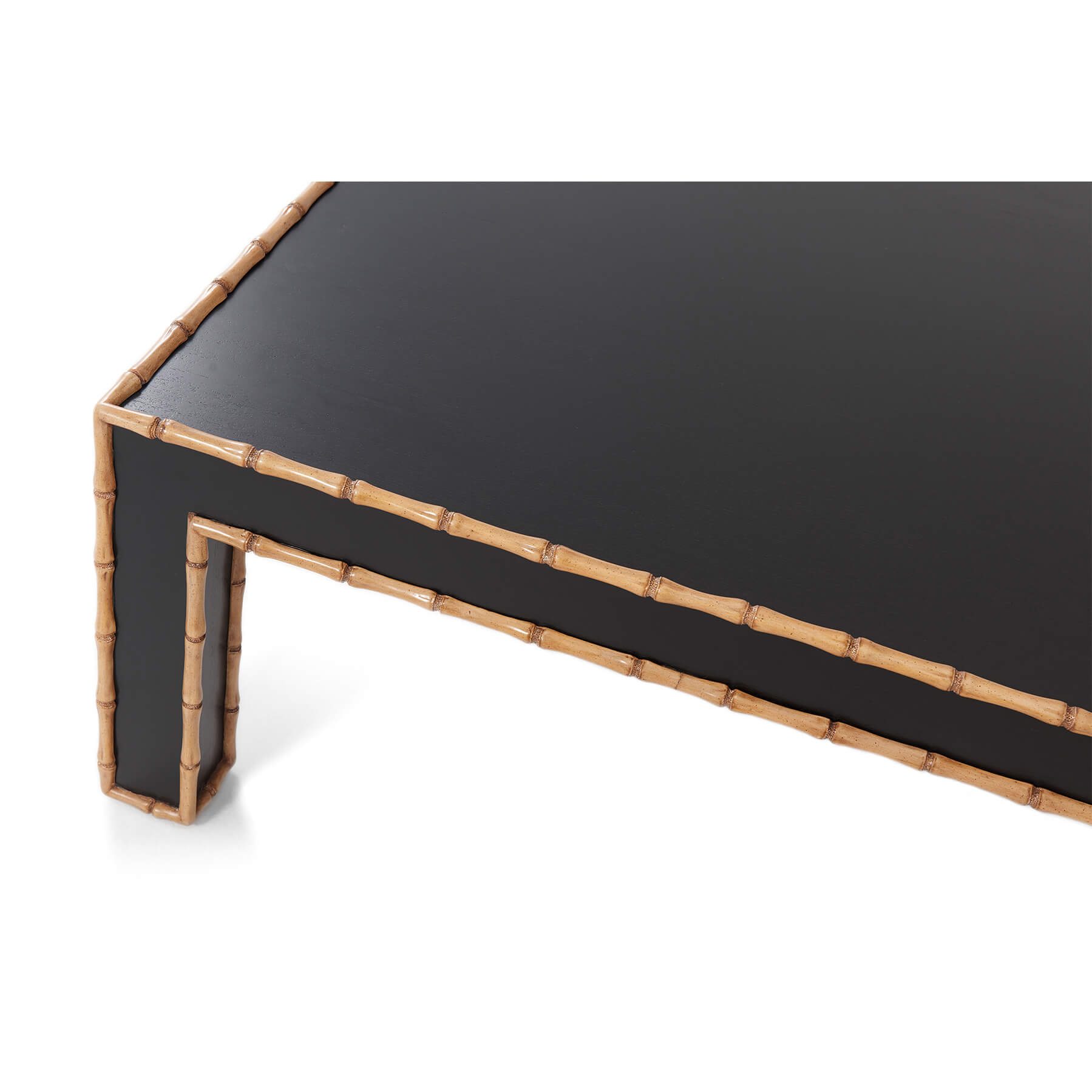 Close-up corner of faux bamboo cocktail table, detailed edges.
