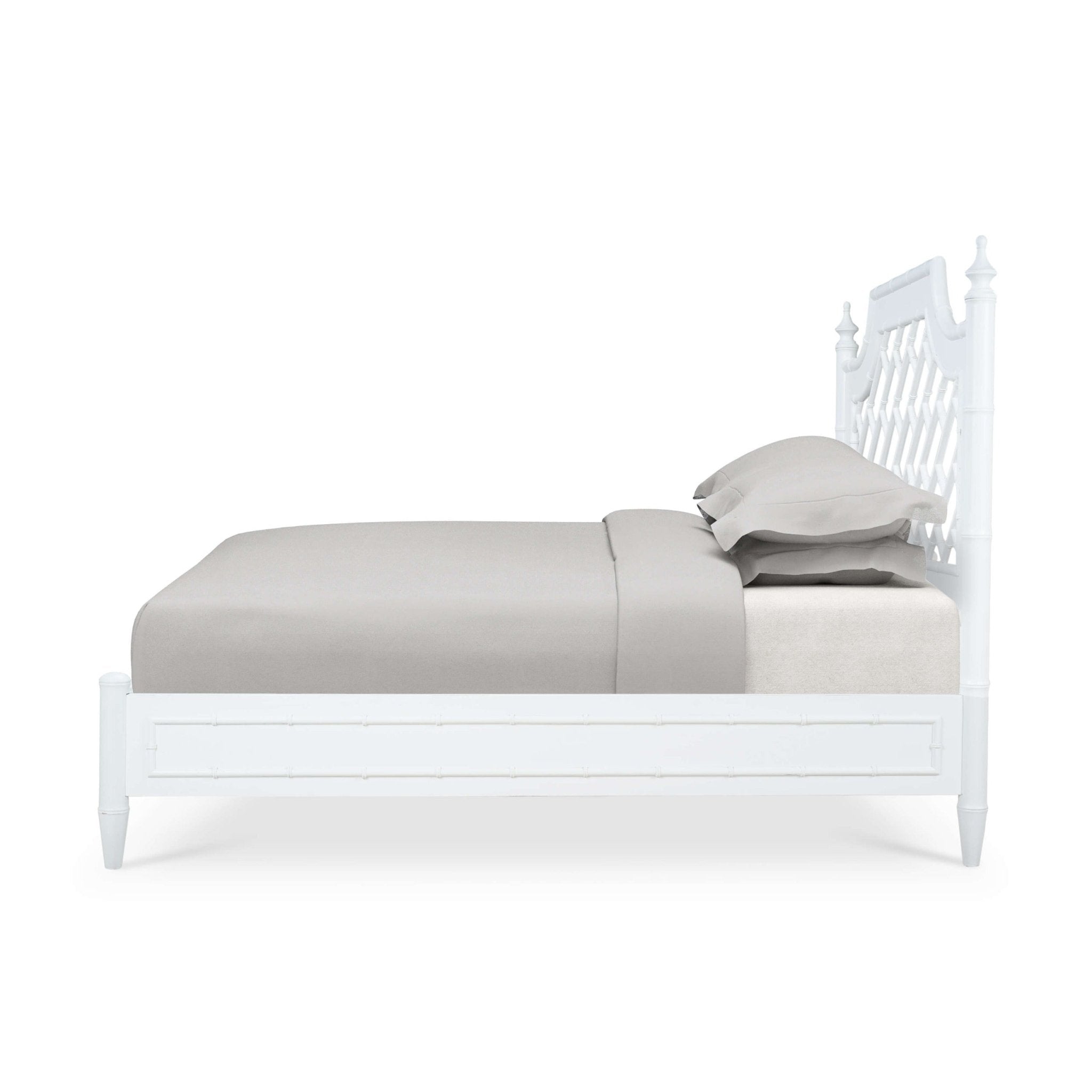 Side profile of white bed showing mattress and pillows.