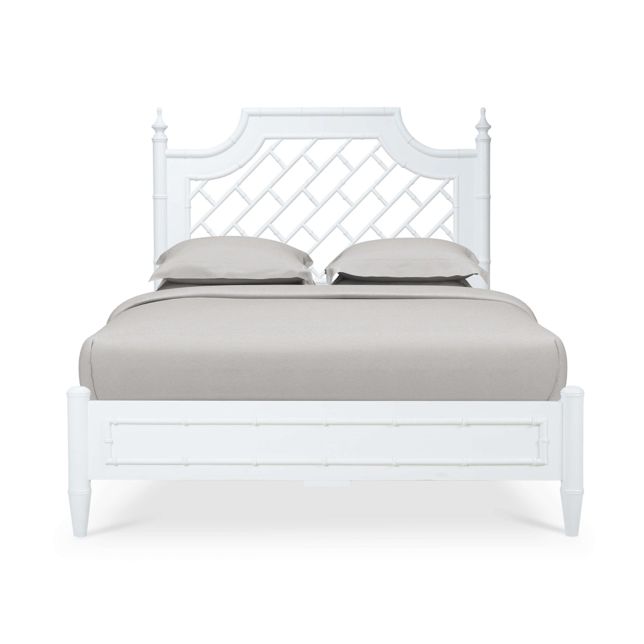 Front view of white queen bed with pillows.