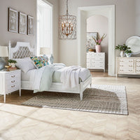 White bed in elegant room setting with decor.