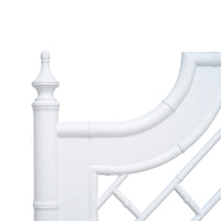 Close-up of white bed headboard detail.