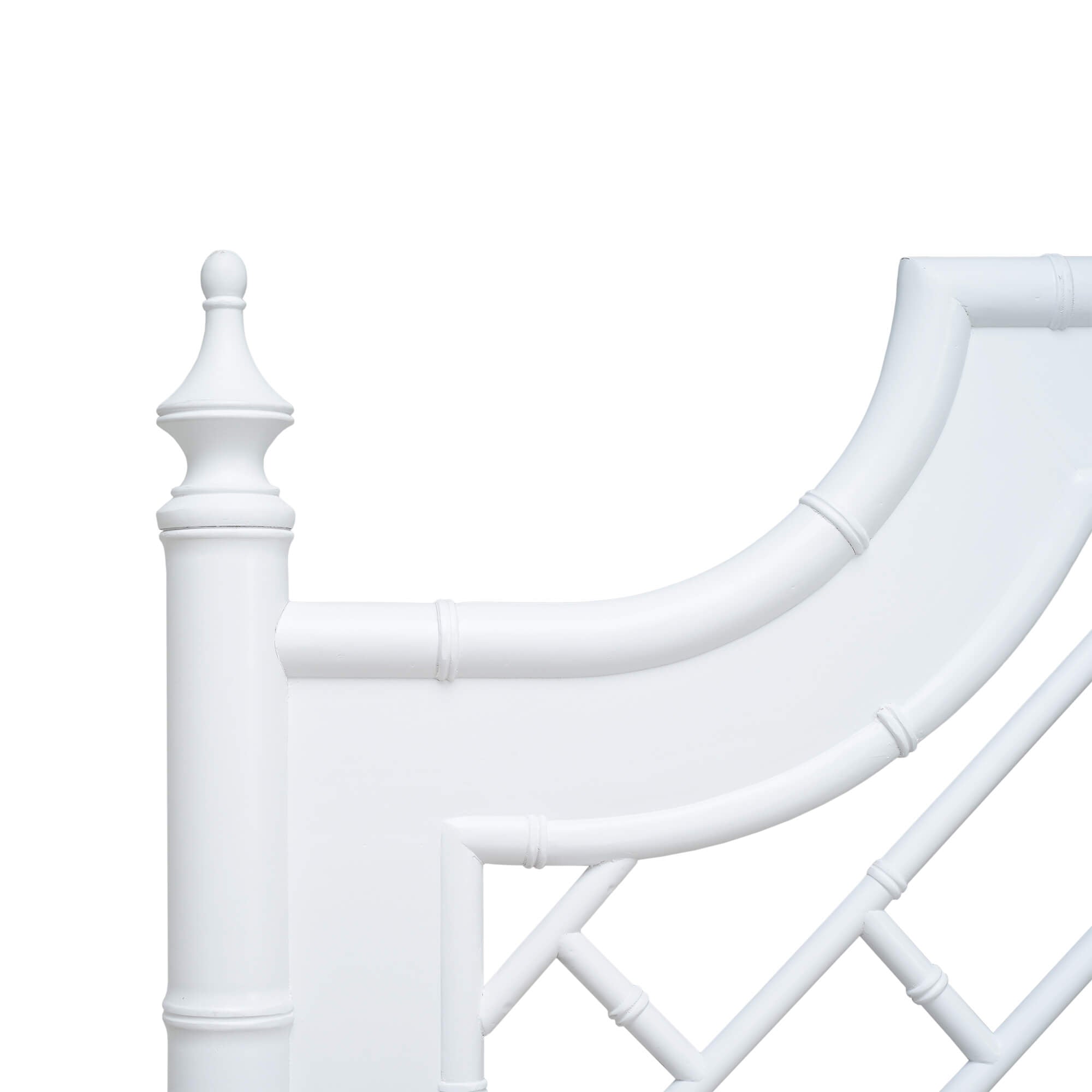 Close-up of white bed headboard detail.