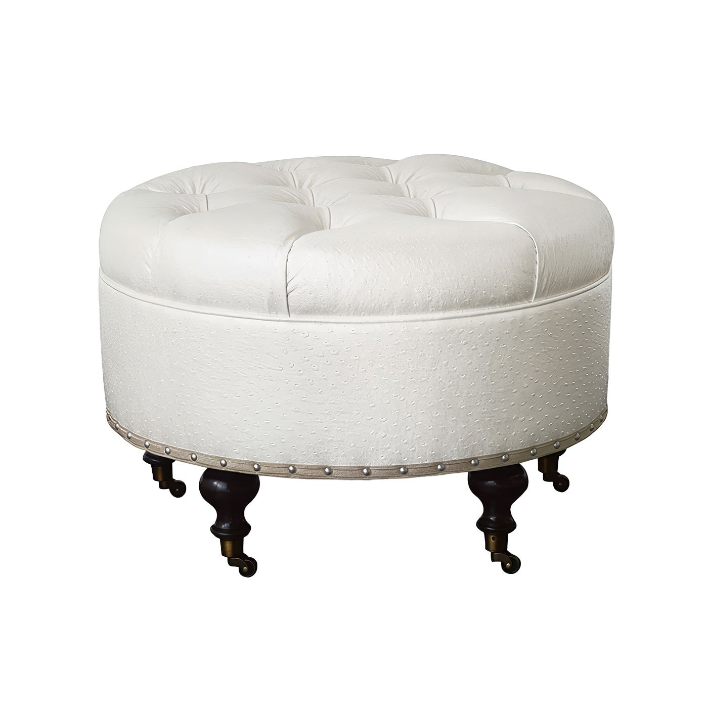 Round white ottoman with dark wooden legs, faux leather texture.