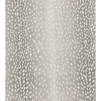 Close-up of fawn pattern fabric on grey ottoman.