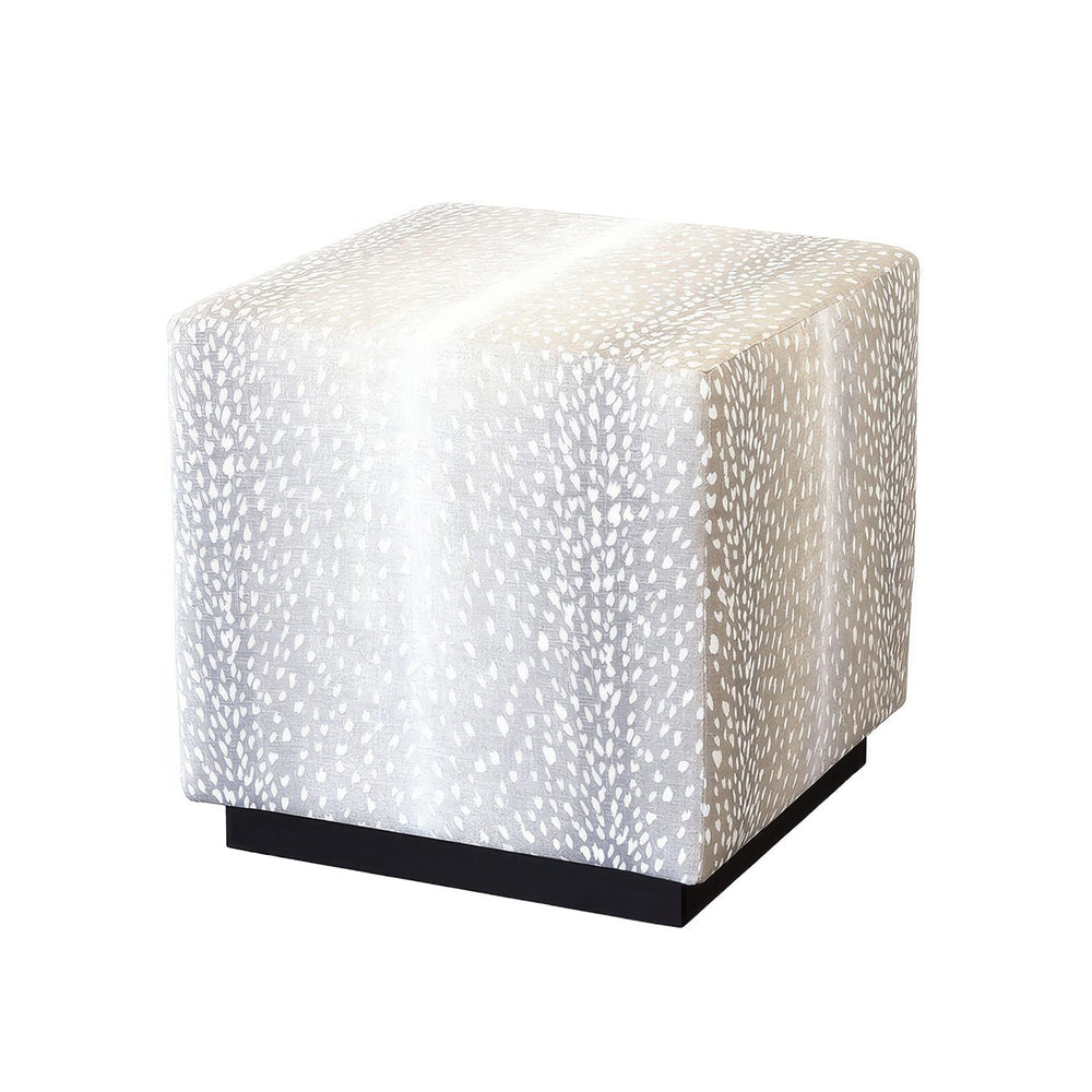 Grey cube ottoman angled view on white backdrop.