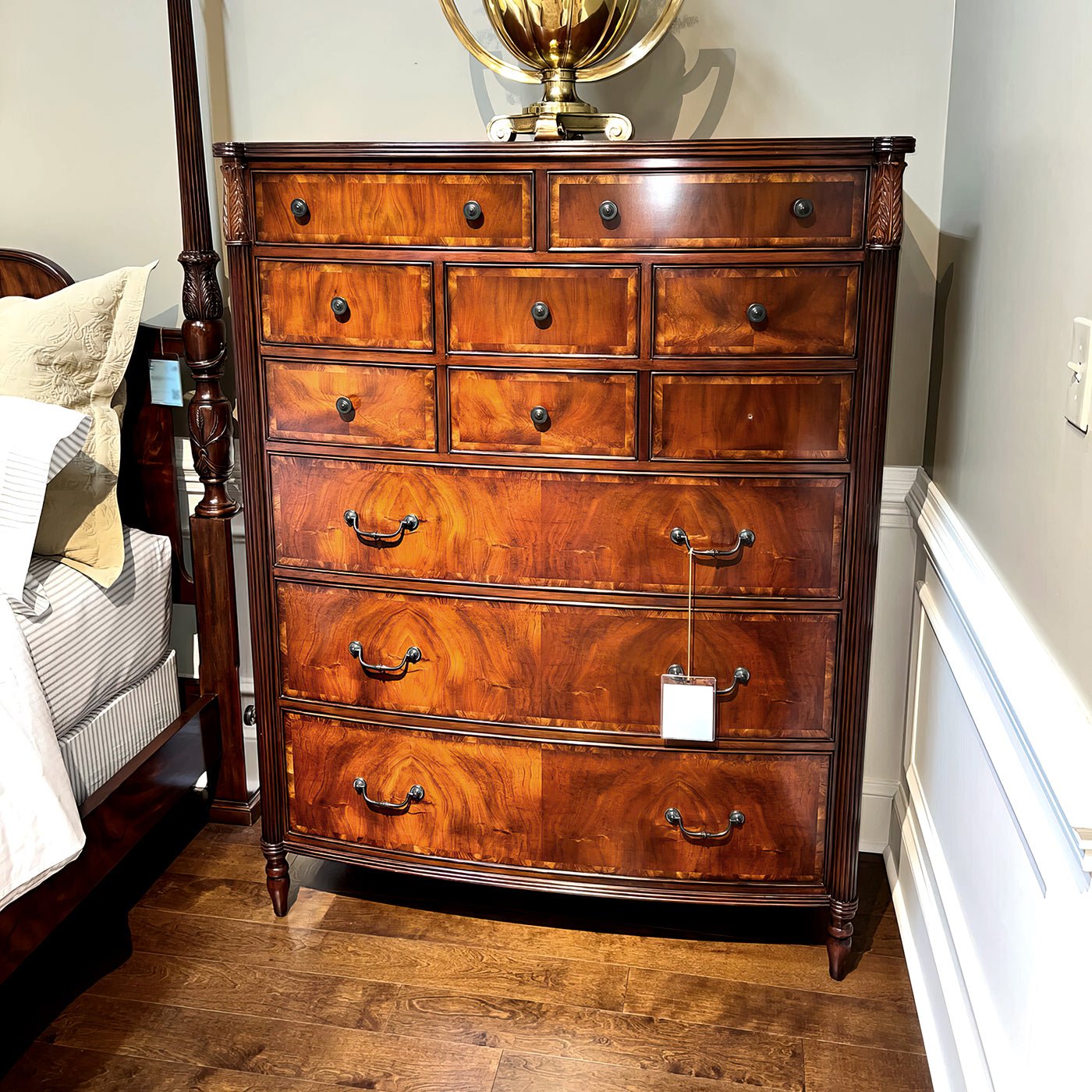 Federal mahogany chest in bedroom setting, decorative piece displayed.