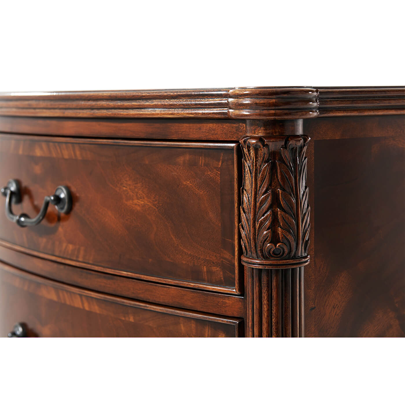 Detailed carving on corner of mahogany bedside chest.