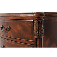 Detailed carving on corner of mahogany bedside chest.