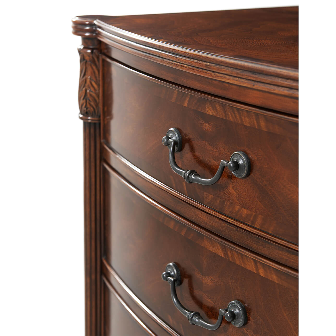 Close-up of drawer handles on mahogany bedside chest.