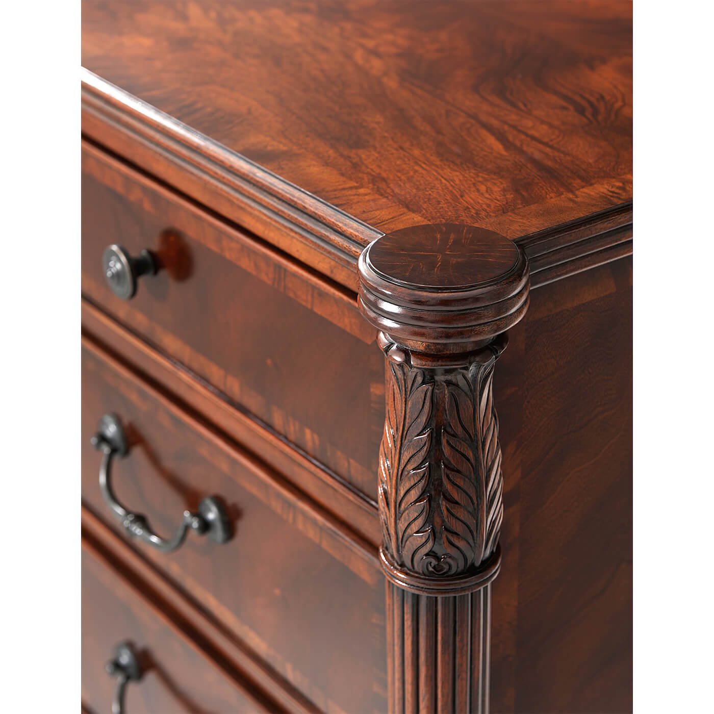 Close-up of carved details on mahogany dresser corner.