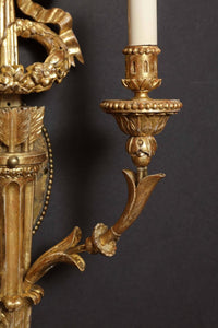 Close-up of sconce's intricate arm and candle holder.