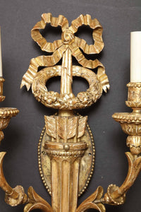 Intricate top detail of carved giltwood sconce.