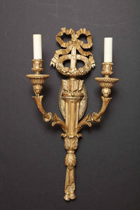 Ornate giltwood sconce with detailed carved elements.