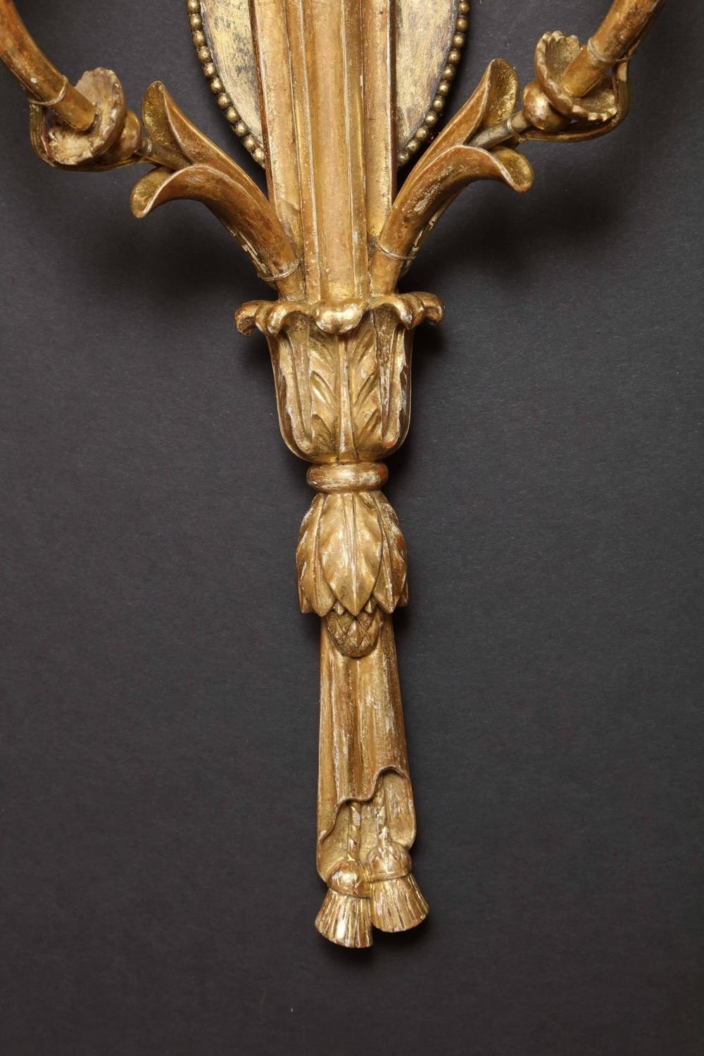 Bottom detail of carved giltwood sconce design.