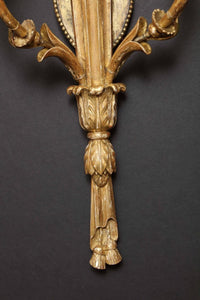 Bottom detail of carved giltwood sconce design.