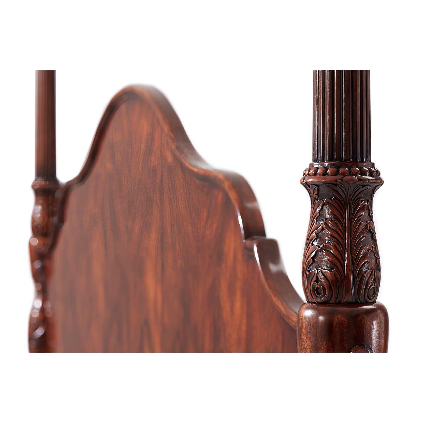Close-up carved details on mahogany bed post.