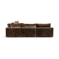 Rear view of brown sectional showing the upholstered back panels and low feet