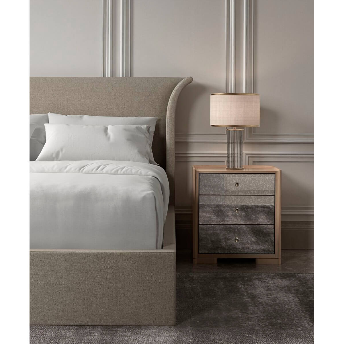 Bed with flared headboard and nightstand with lamp.