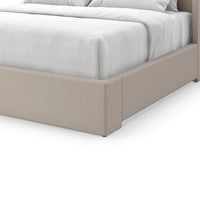 Close-up of flared upholstered king bed's footboard.