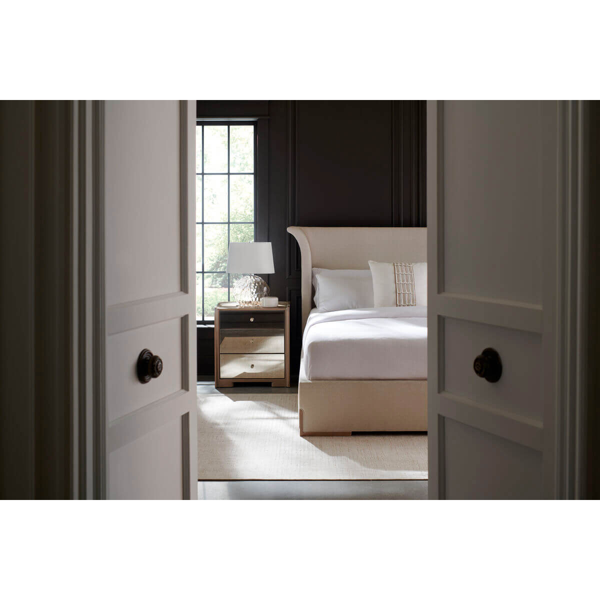 Bedroom interior with flared modern king upholstered bed.
