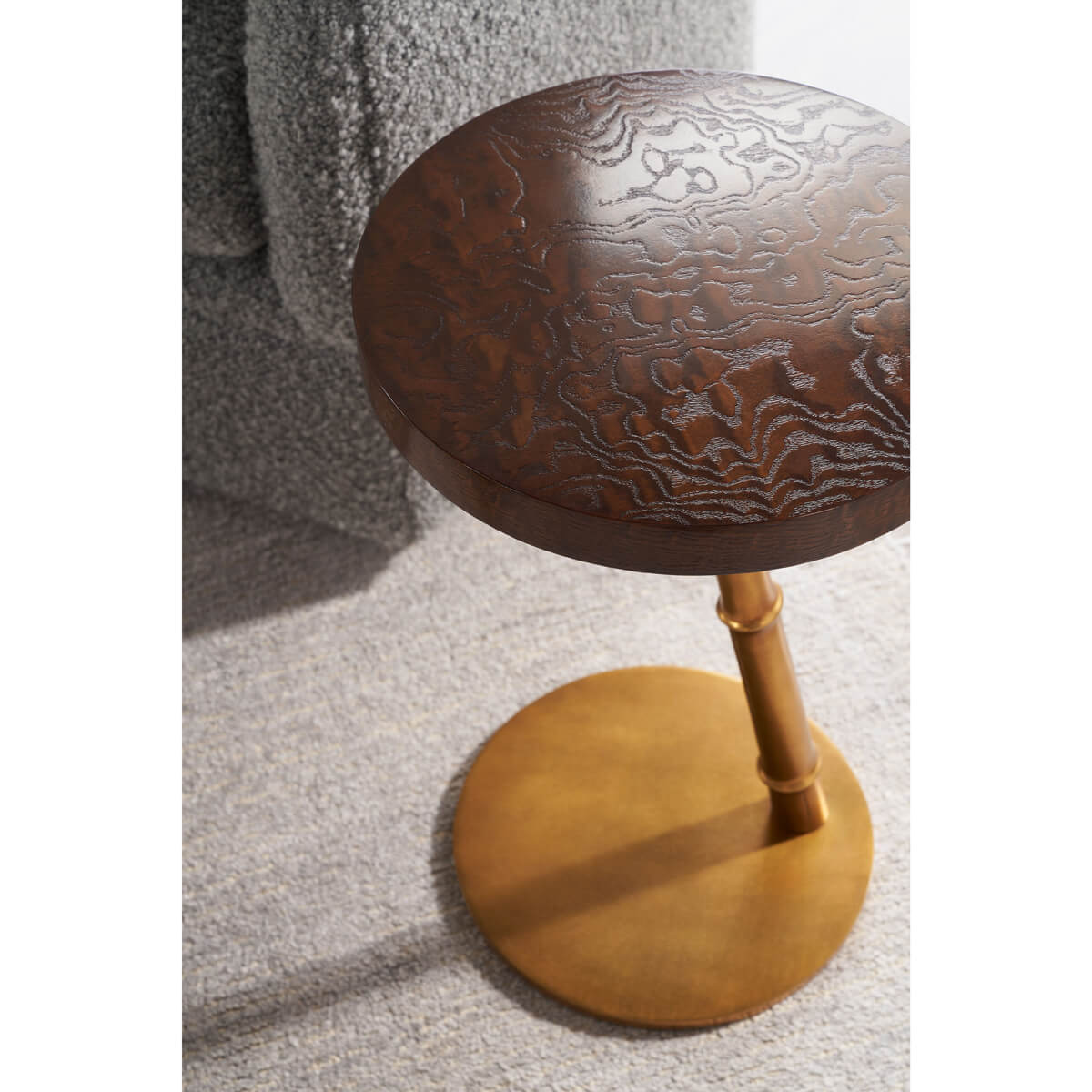 Overhead view of floating burl accent table next to sofa.