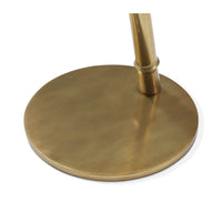 Close-up of floating burl accent table brass base.