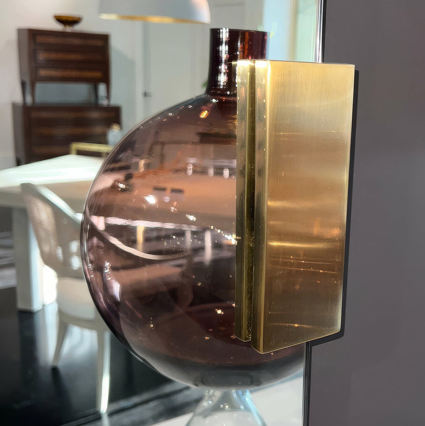 Close-up of brass detail on modern mirror.