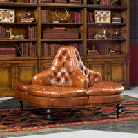 Brown leather lobby sofa in library setting, elegant décor.