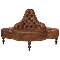 Three-sided brown leather lobby sofa, tufted design.