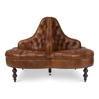 Front view of brown leather lobby sofa, tufted details.