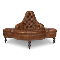 Side perspective of round brown leather lobby sofa.